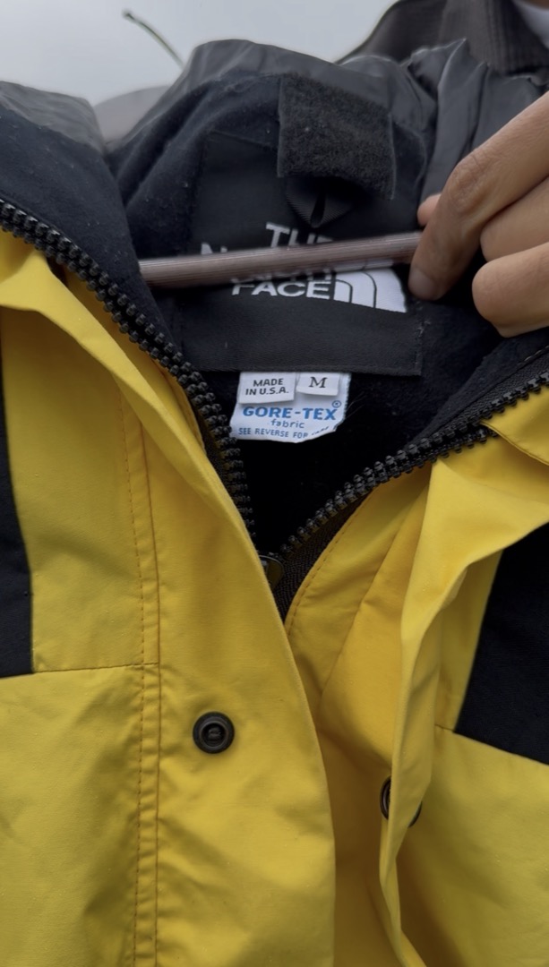 Video frame: the jacket's size tag