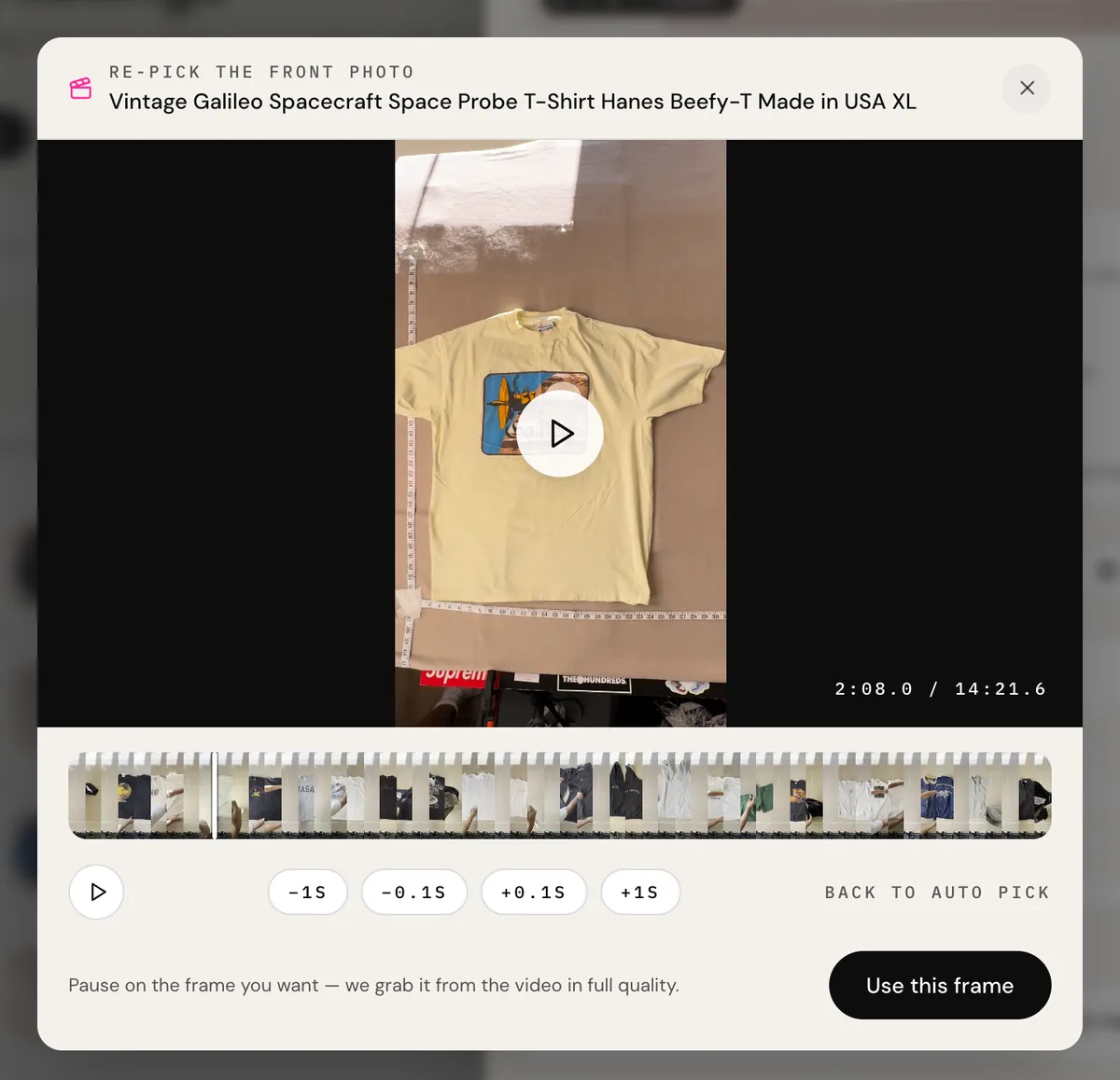 The real frame picker: the walkthrough video paused on the Galileo tee laid out flat, a filmstrip of thumbnails across the whole video, nudge buttons, and a Use this frame button.