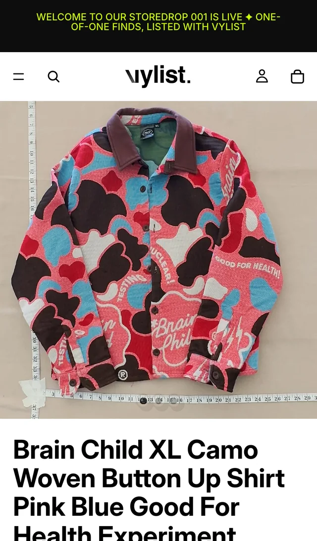 The same camo shirt on the Vylist Shopify storefront, shop.vylist.ai, with the storedrop announcement bar.