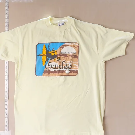 Grid tile of the raw front photo: the square crop chops the tee's sleeves and pulls in the tape measures.